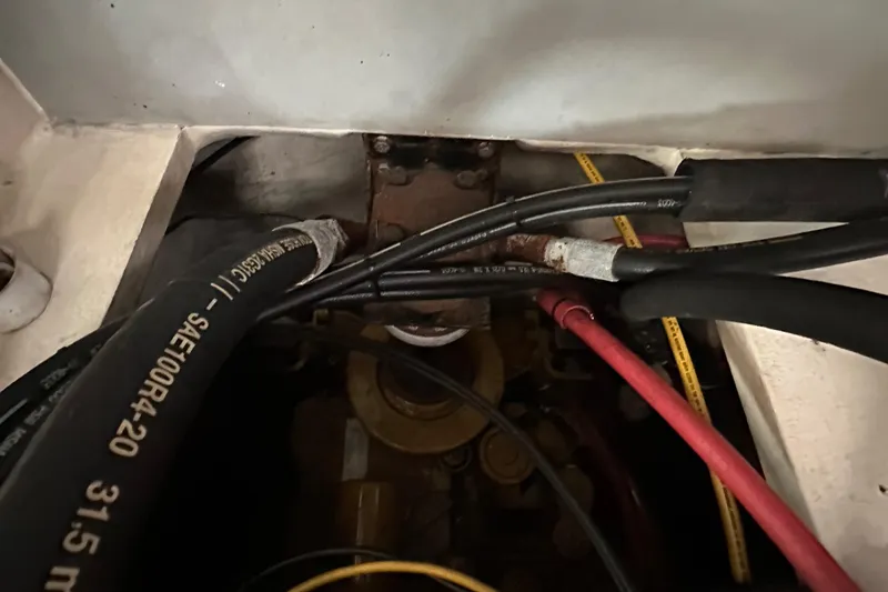 Slide: The Image of Engine compartment of a 2003 BHM Sport Fish boat, showing hoses and wiring. - 33