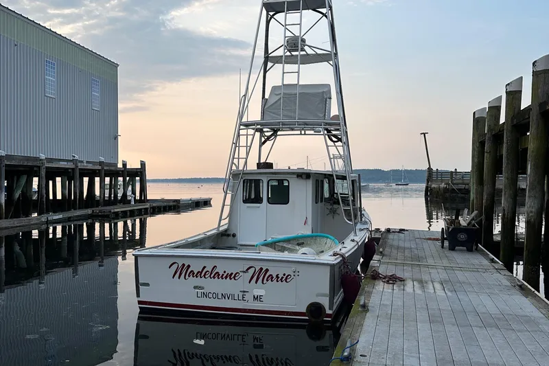 Slide: The Image of BHM Sport Fish 2003 boat docked at Lincolnville, ME, during a serene sunset. - 5
