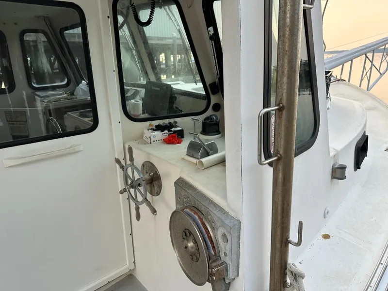 Slide: The Image of 2003 BHM Sport Fish boat cockpit with steering wheel and navigation equipment. - 6