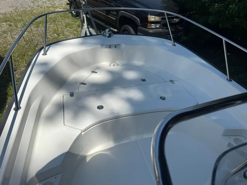 Slide: The Image of 2022 Boston Whaler 170 Montauk boat deck with railing, parked outdoors. - 38