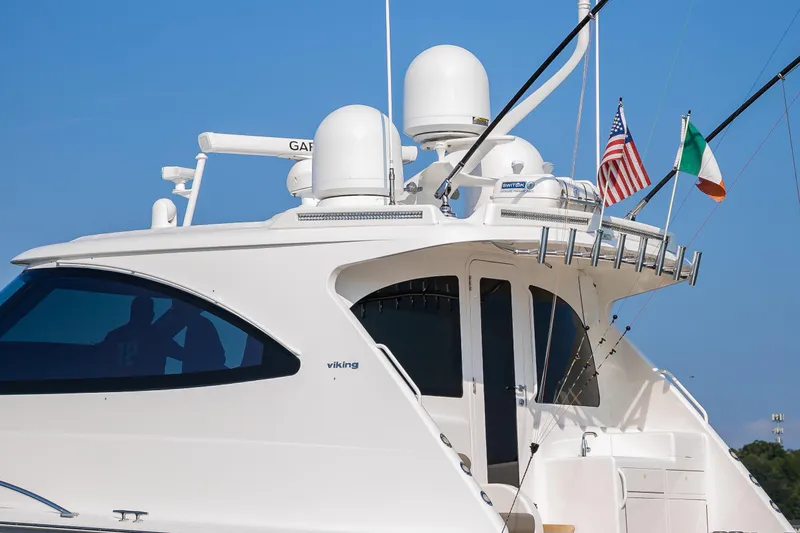 Slide: The Image of 2022 Viking 54 Sport Coupe yacht on calm blue waters, rear view. - 11