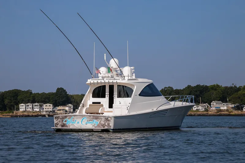 Slide: The Image of 2022 Viking 54 Sport Coupe cruising on open water. - 13