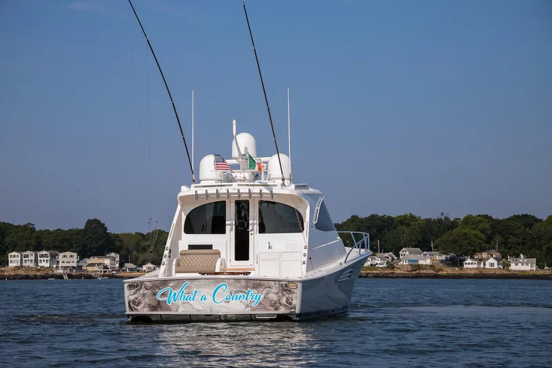 Slide: The Image of Aerial view of 2022 Viking 54 Sport Coupe yacht on dark water. - 16