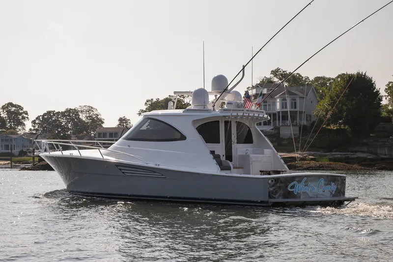 Slide: The Image of Aerial view of 2022 Viking 54 Sport Coupe yacht cruising on water. - 17