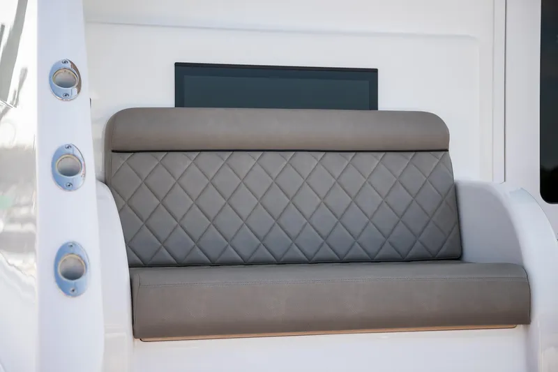Slide: The Image of 2022 Viking 54 Sport Coupe yacht interior with seating, storage, and engine access. - 19