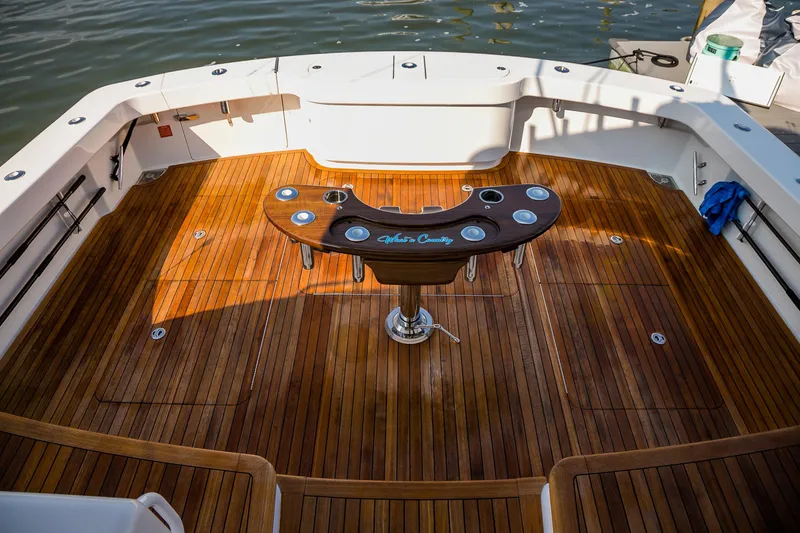 Slide: The Image of 2022 Viking 54 Sport Coupe interior with sonar display and cushioned seating. - 24