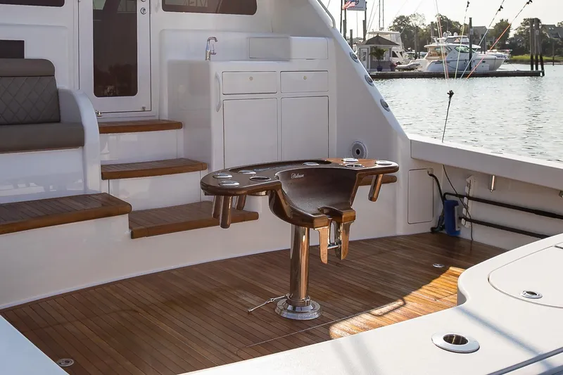 Slide: The Image of Polished wood detail on 2022 Viking 54 Sport Coupe yacht, featuring "Release" inscription. - 28