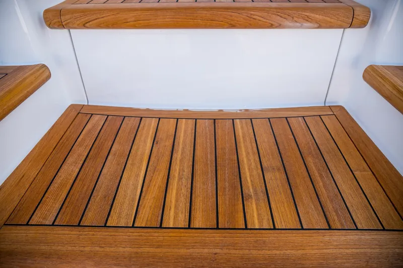 Slide: The Image of Luxurious interior of 2022 Viking 54 Sport Coupe yacht with leather seating and wooden cabinetry. - 54