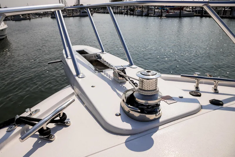 Slide: The Image of Wooden storage compartments inside a 2022 Viking 54 Sport Coupe yacht. - 56