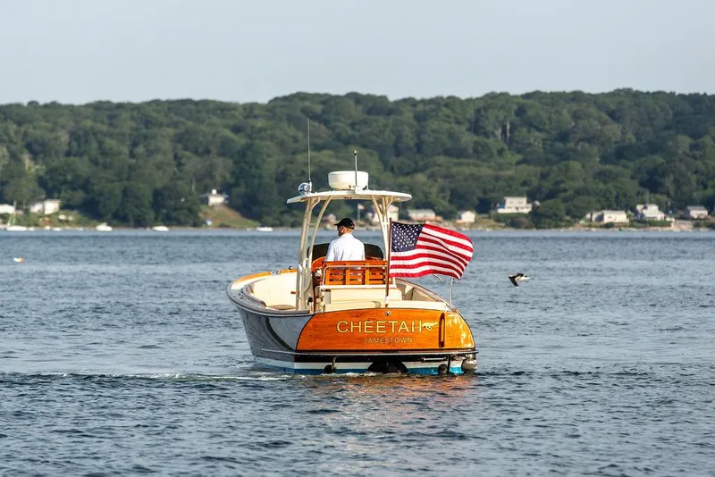 Slide: The Image of Hinckley T29 CC boat on water, American flag, scenic background, 2014 model. - 17