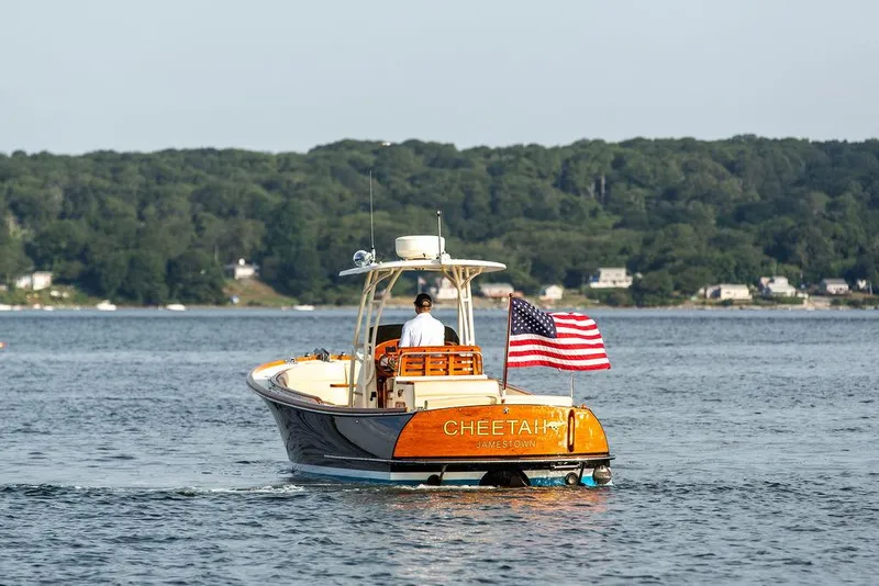 Slide: The Image of 2014 Hinckley T29 CC boat on water, American flag, scenic background. - 18