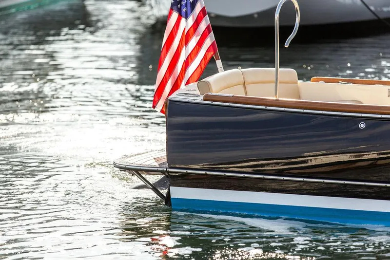 Slide: The Image of Hinckley T29 CC 2014 boat with American flag on water. - 28