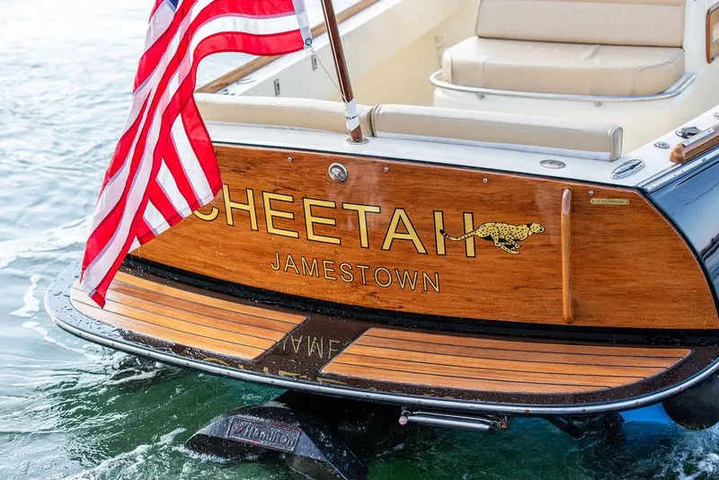 Slide: The Image of Hinckley T29 CC 2014 boat with American flag and "Cheetah" nameplate on wooden stern. - 29