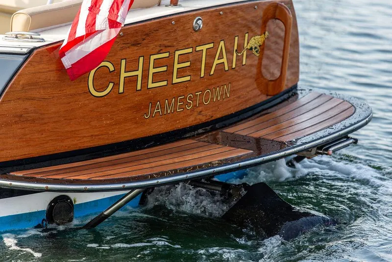 Slide: The Image of Hinckley T29 CC 2014 boat named "Cheetah" with American flag on water. - 30