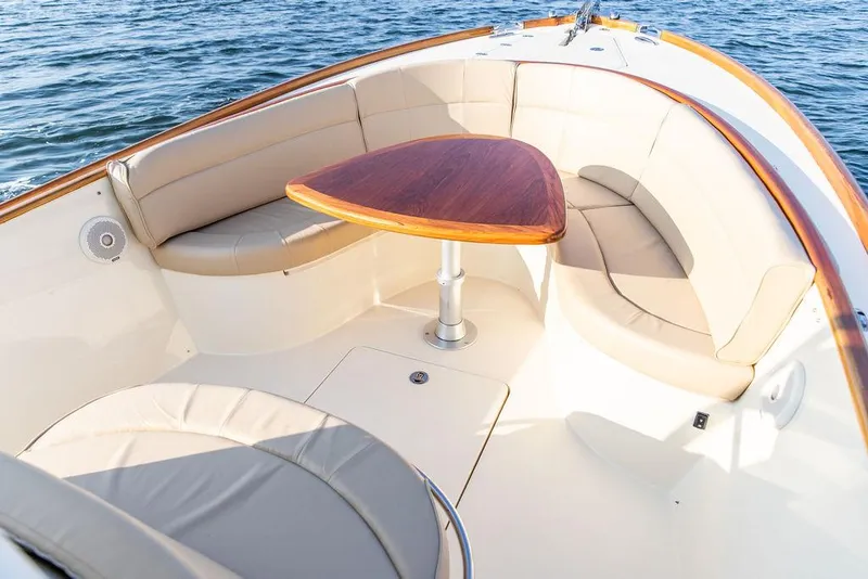 Slide: The Image of Luxurious seating area on a 2014 Hinckley T29 CC boat with elegant wood table. - 38