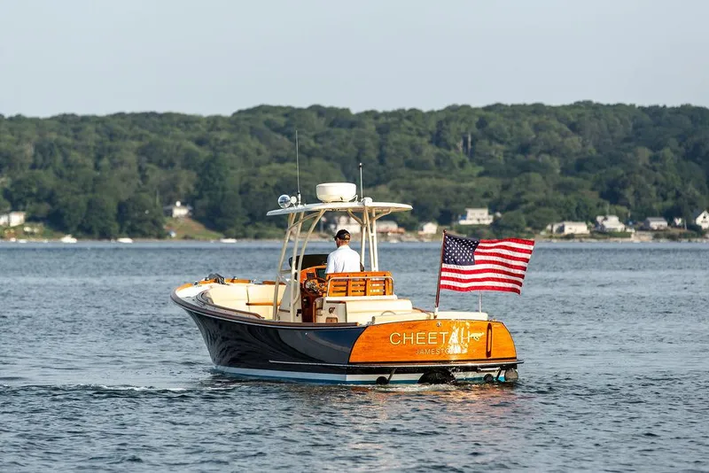 Slide: The Image of 2014 Hinckley T29 CC boat on water with American flag, scenic background. - 19