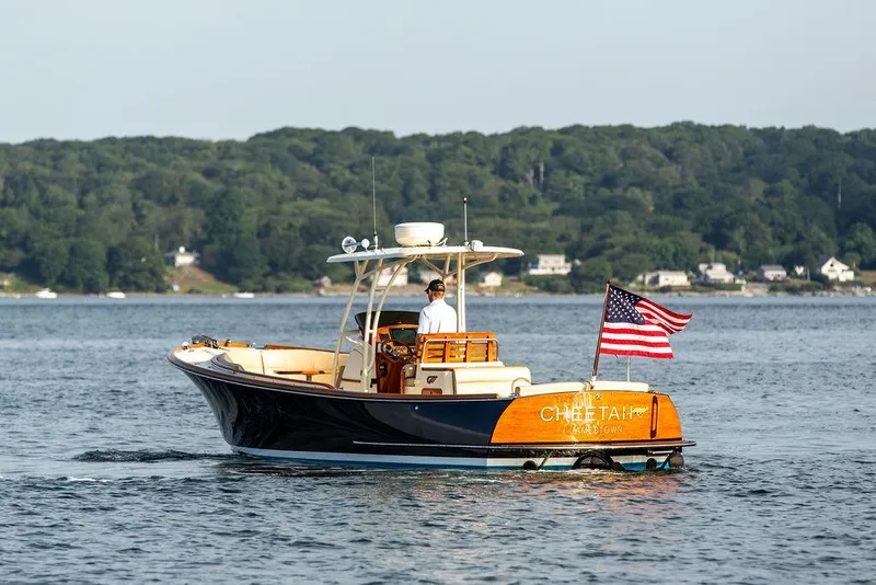 Slide: The Image of 2014 Hinckley T29 CC boat on water with American flag, scenic background. - 20