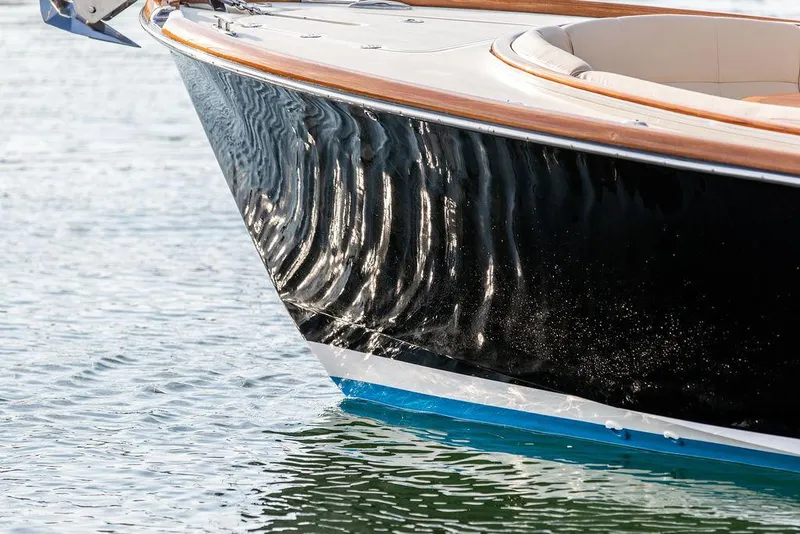 Slide: The Image of 2014 Hinckley T29 CC boat with sleek black hull on water. - 24