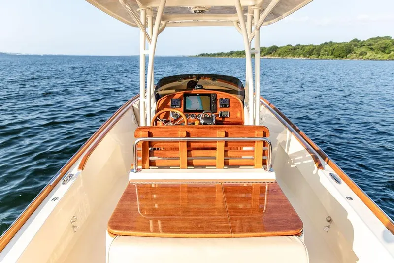 Slide: The Image of 2014 Hinckley T29 CC boat with wooden dashboard on open water. - 37