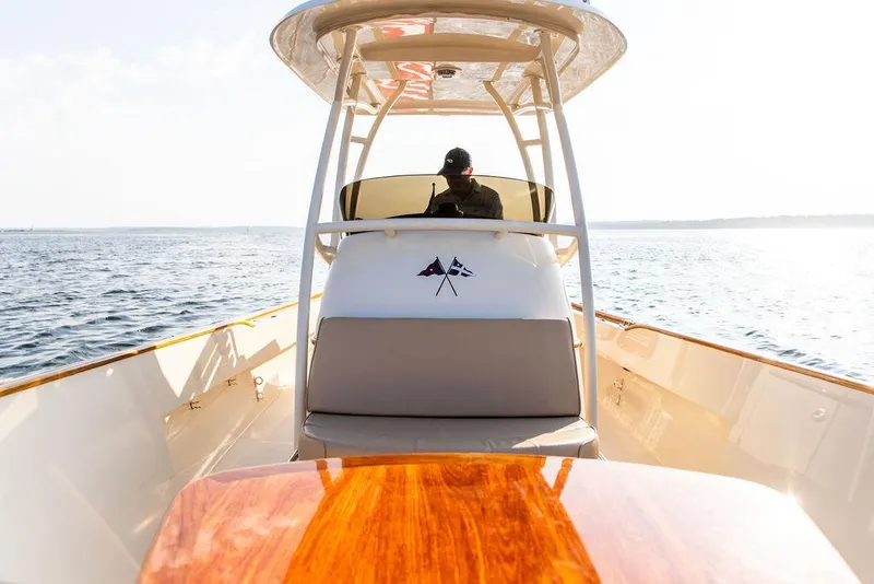 Slide: The Image of 2014 Hinckley T29 CC boat cruising on open water, sunny day. - 42