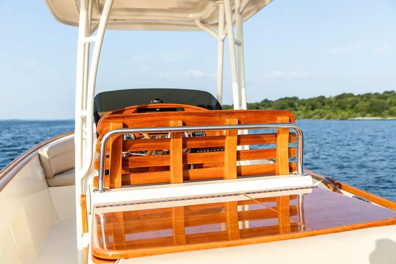 Slide: The Image of 2014 Hinckley T29 CC boat with polished wood finish on open water. - 44