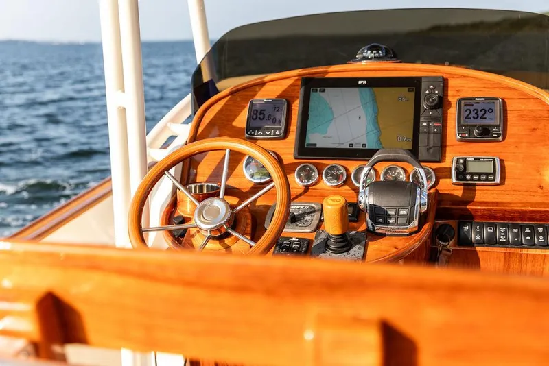 Slide: The Image of Helm of 2014 Hinckley T29 CC boat with navigation instruments and wooden steering wheel. - 47