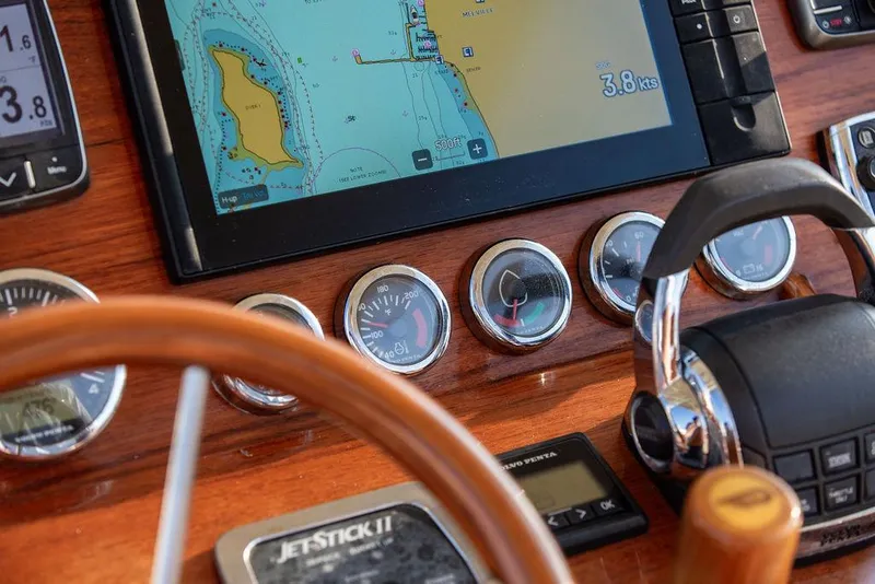 Slide: The Image of Hinckley T29 CC 2014 dashboard with navigation screen and controls, showcasing nautical instruments. - 49