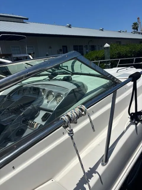 Slide: The Image of 2007 Monterey 350 Sport Yacht with sleek dashboard and mooring rope, docked under clear blue sky. - 13