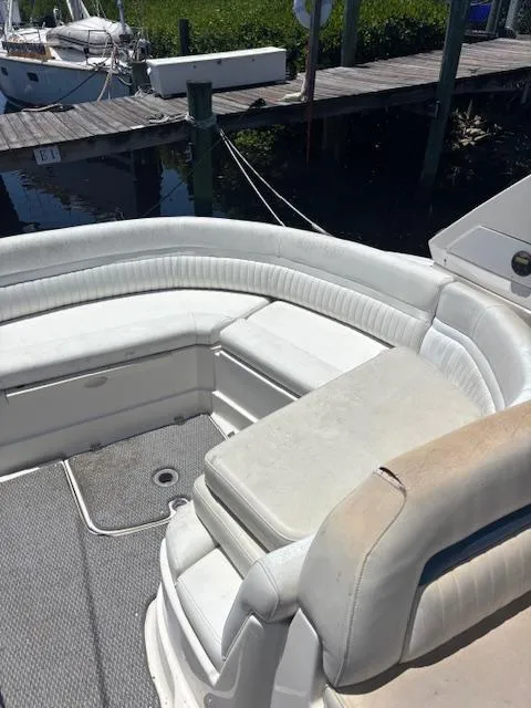 Slide: The Image of 2007 Monterey 350 Sport Yacht interior with white seating and docked at marina. - 16