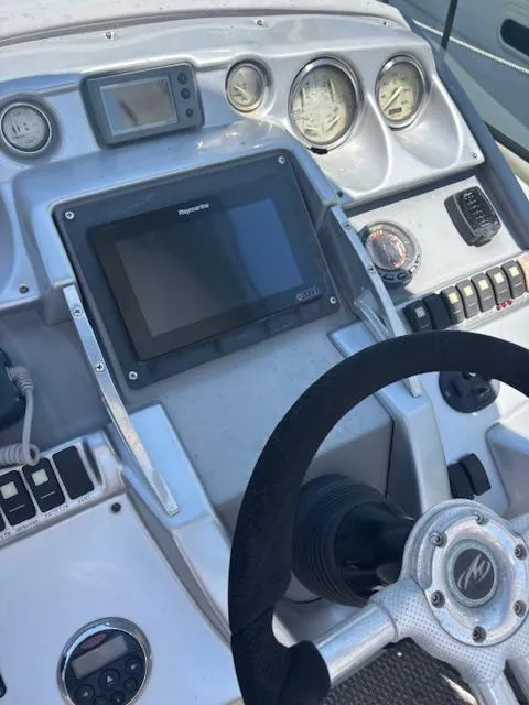 Slide: The Image of Control panel of a 2007 Monterey 350 Sport Yacht with steering wheel and gauges. - 17