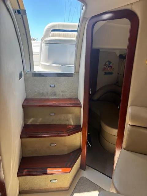 Slide: The Image of Interior view of a 2007 Monterey 350 Sport Yacht with wooden steps and cozy cabin. - 21