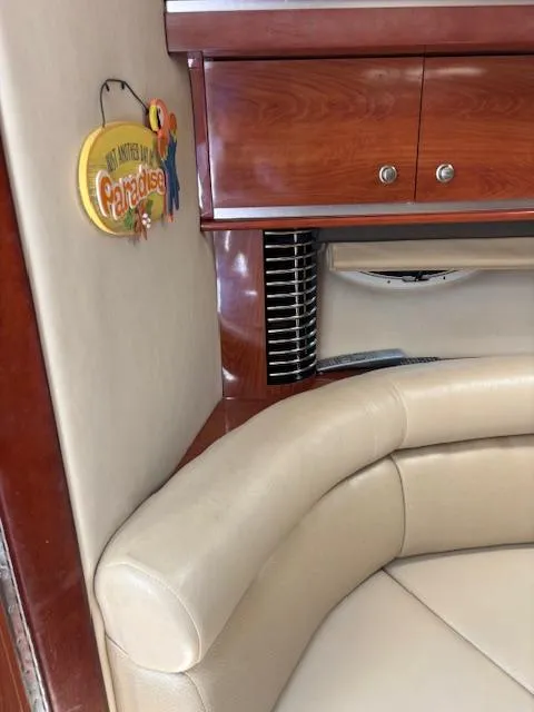 Slide: The Image of Interior of 2007 Monterey 350 Sport Yacht with beige seating and wooden cabinetry. - 25