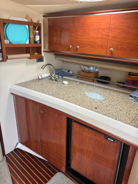 Slide: The Image of 2007 Monterey 350 Sport Yacht kitchen with wood cabinets and granite countertop. - 26