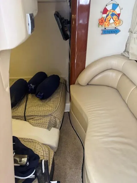 Slide: The Image of Interior of 2007 Monterey 350 Sport Yacht with beige seating and nautical decor. - 30