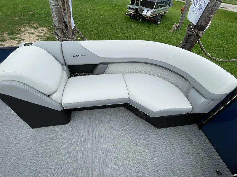 Slide: The Image of Luxurious seating on 2026 Lowe SS 230 WT Special boat, featuring white upholstery and elegant design. - 10