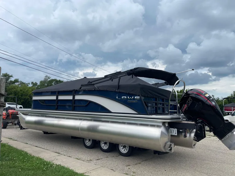 Slide: The Image of 2026 Lowe SS 230 WT Special pontoon boat on trailer under cloudy sky. - 2