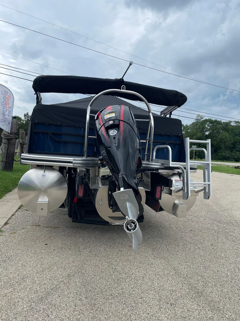 Slide: The Image of 2026 Lowe SS 230 WT Special boat with outboard motor, parked on a paved surface. - 3