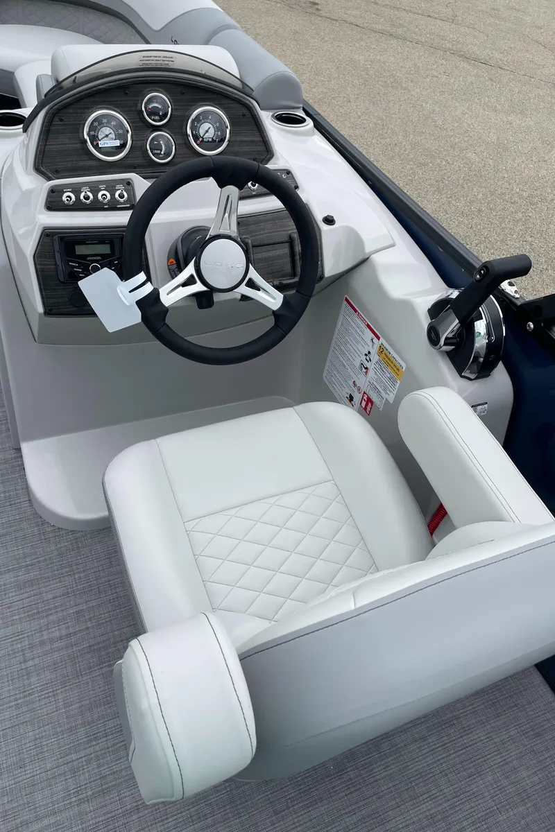Slide: The Image of 2026 Lowe SS 230 WT Special boat interior with steering wheel and white cushioned seat. - 7