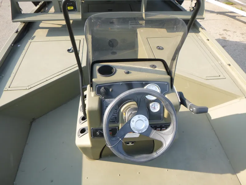 Slide: The Image of 2024 Tracker Grizzly 2072 CC Sportsman boat console with steering wheel and gauges. - 12