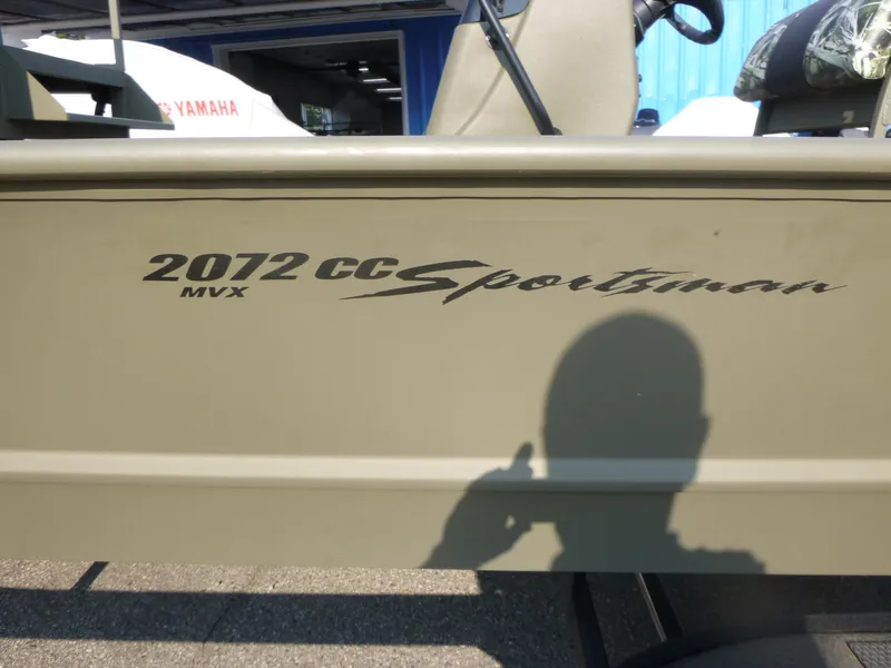 Slide: The Image of 2024 Tracker Grizzly 2072 CC Sportsman boat with shadow on side panel. - 14