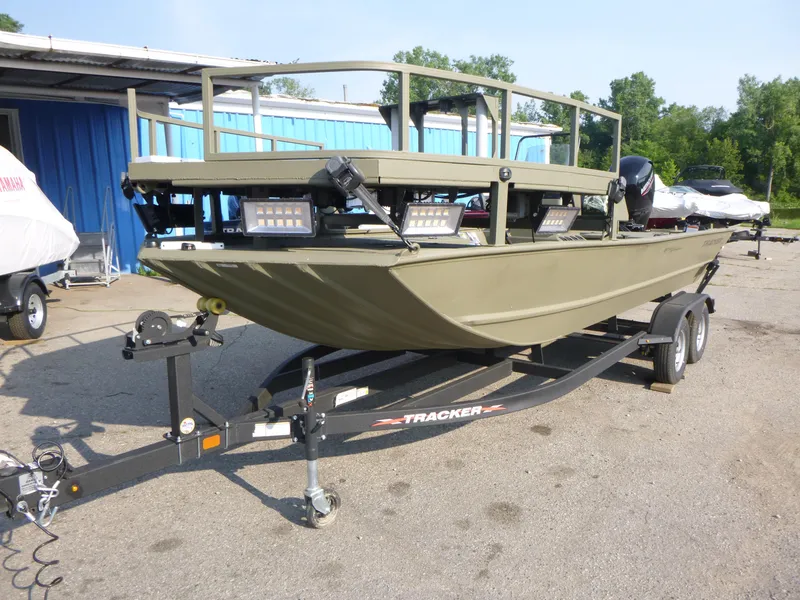 Slide: The Image of 2024 Tracker Grizzly 2072 CC Sportsman boat on trailer, parked outdoors. - 3