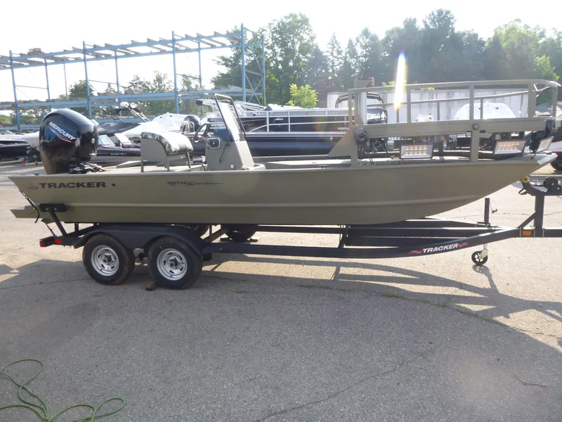 Slide: The Image of 2024 Tracker Grizzly 2072 CC Sportsman boat on trailer, parked outdoors. - 4