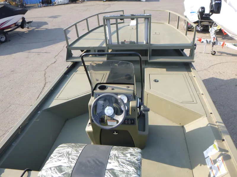 Slide: The Image of 2024 Tracker Grizzly 2072 CC Sportsman boat interior with steering console and seating. - 5