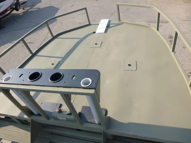 Slide: The Image of 2024 Tracker Grizzly 2072 CC Sportsman boat deck with railing and cup holders. - 7