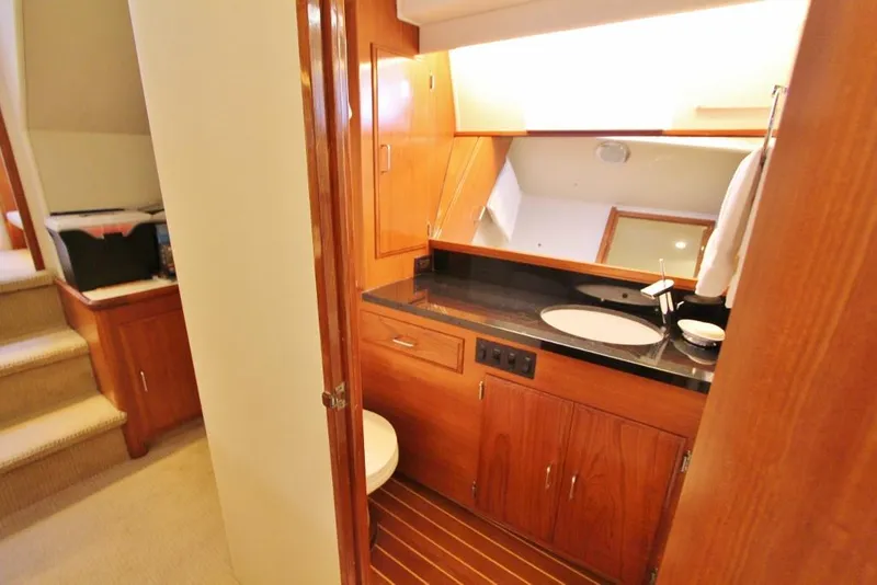 Slide: The Image of 1992 Tollycraft 53 Motor Yacht bathroom with wooden cabinetry and modern fixtures. - 11