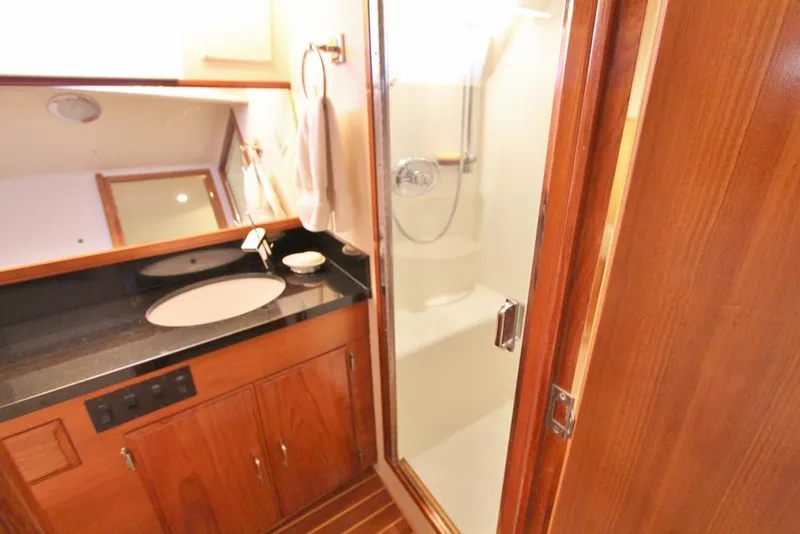 Slide: The Image of Luxurious bathroom in 1992 Tollycraft 53 Motor Yacht with wood cabinetry and glass shower. - 12