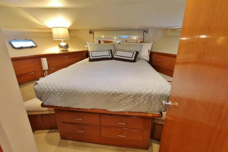 Slide: The Image of Luxurious bedroom interior of 1992 Tollycraft 53 Motor Yacht with elegant wood finish. - 14
