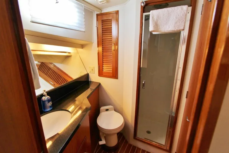 Slide: The Image of Bathroom interior of 1992 Tollycraft 53 Motor Yacht with shower and wooden accents. - 15