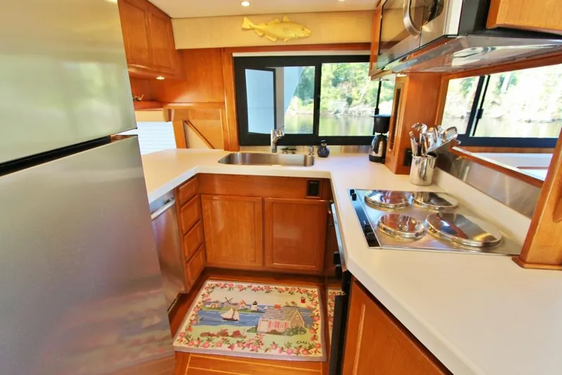Slide: The Image of Luxurious kitchen interior of 1992 Tollycraft 53 Motor Yacht with modern appliances. - 17