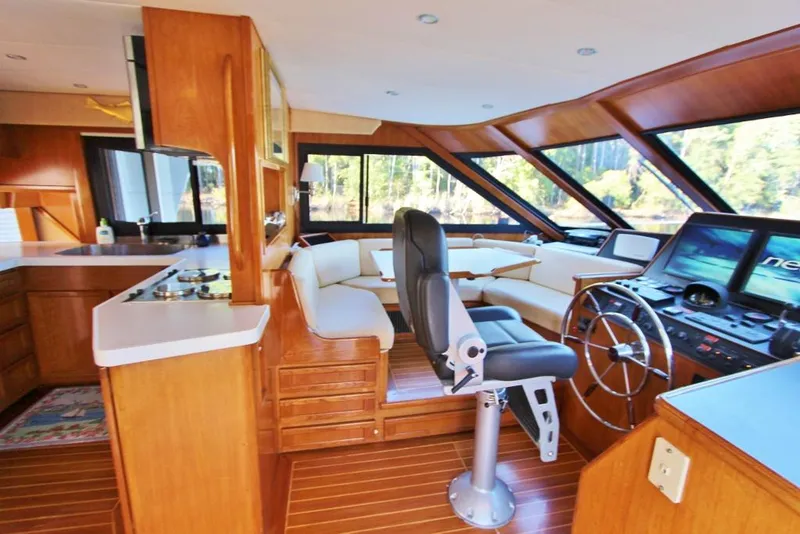 Slide: The Image of Interior of 1992 Tollycraft 53 Motor Yacht with helm, seating, and wooden finishes. - 4